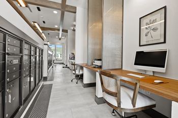 a long hallway with desks and filing cabinets and a computer